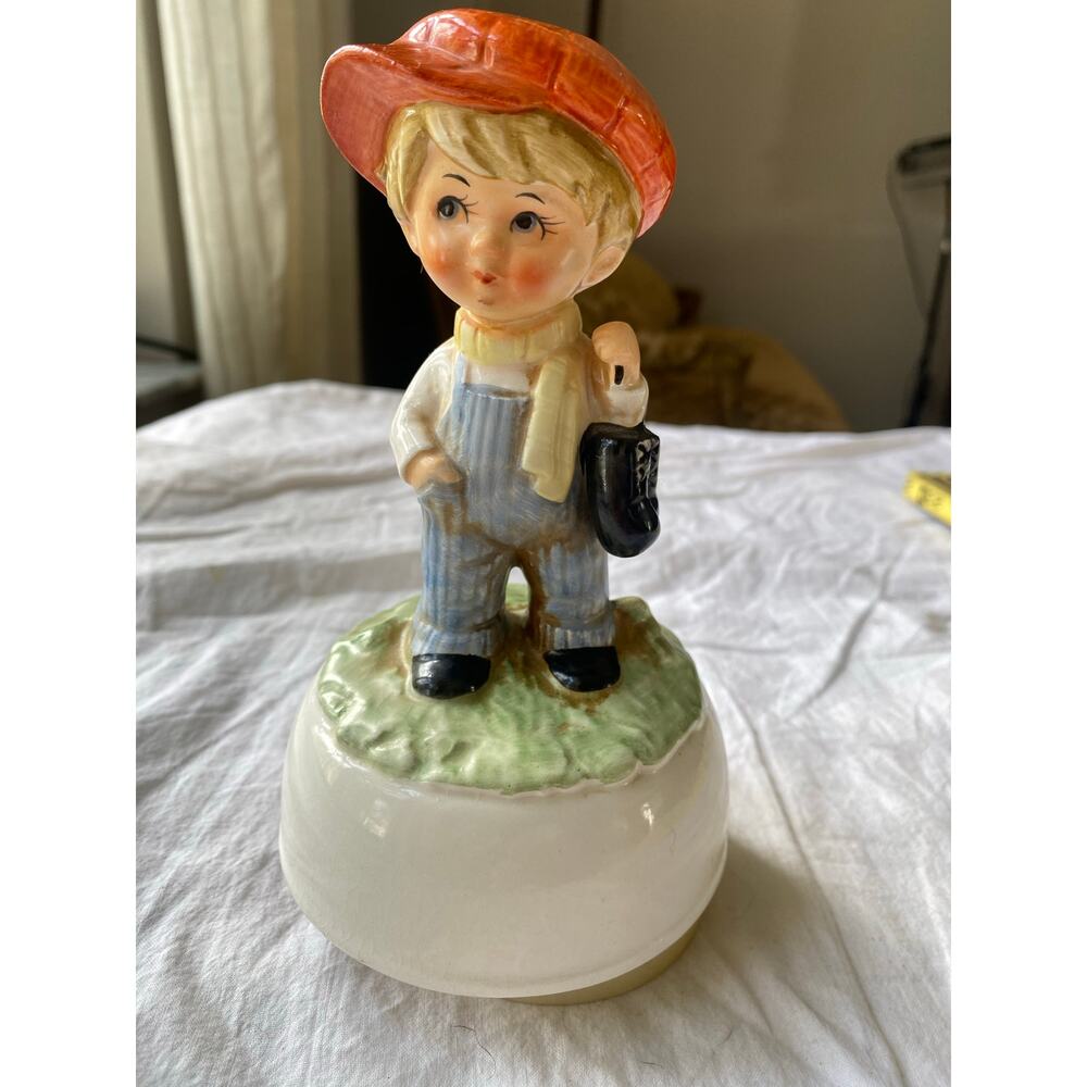 vintage Schmid Bros Japanese musical spinning figure depicting a boy in overalls